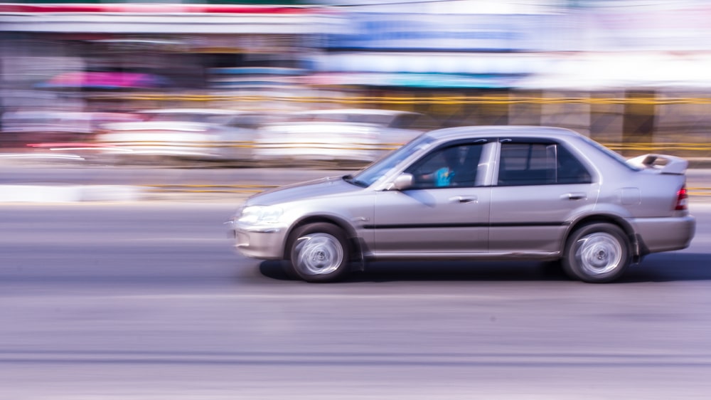 Grey Car Speeding On A Road